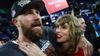 Travis-Kelce-87-of-the-Kansas-City-Chiefs-L-celebrates-with-Taylor-Swift-after-defeating-the-Baltimore-Ravens-in-the-AFC-Championship-Game-aspect-ratio-16-9